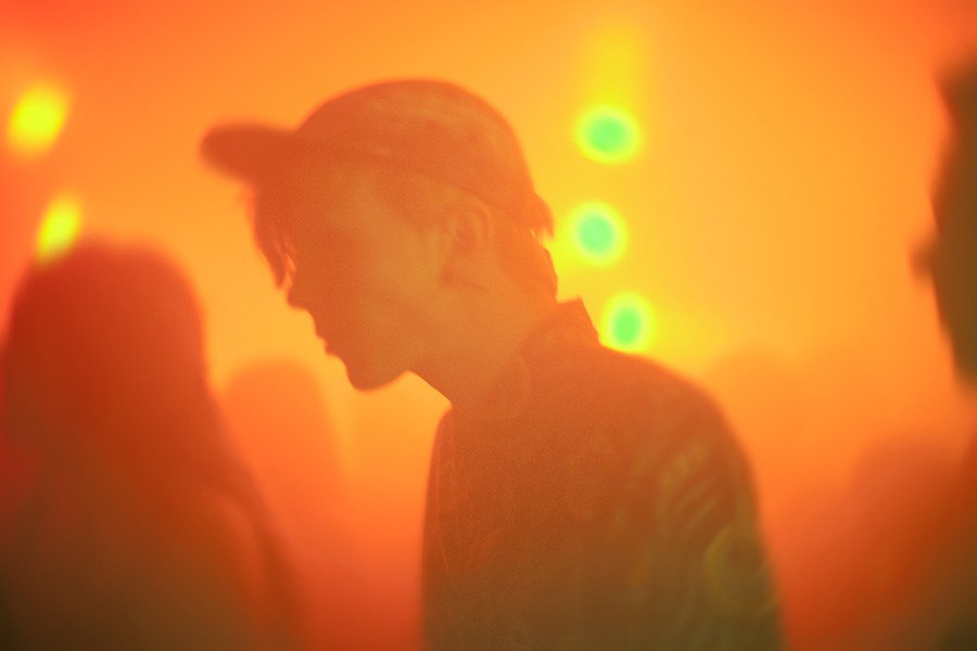 Portrait in orange light on the dance floor