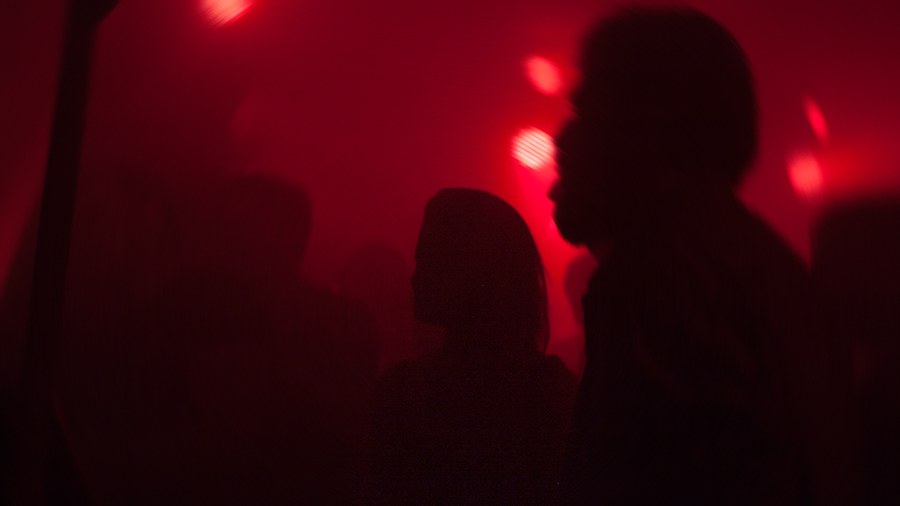 Silhouettes in deep red club light