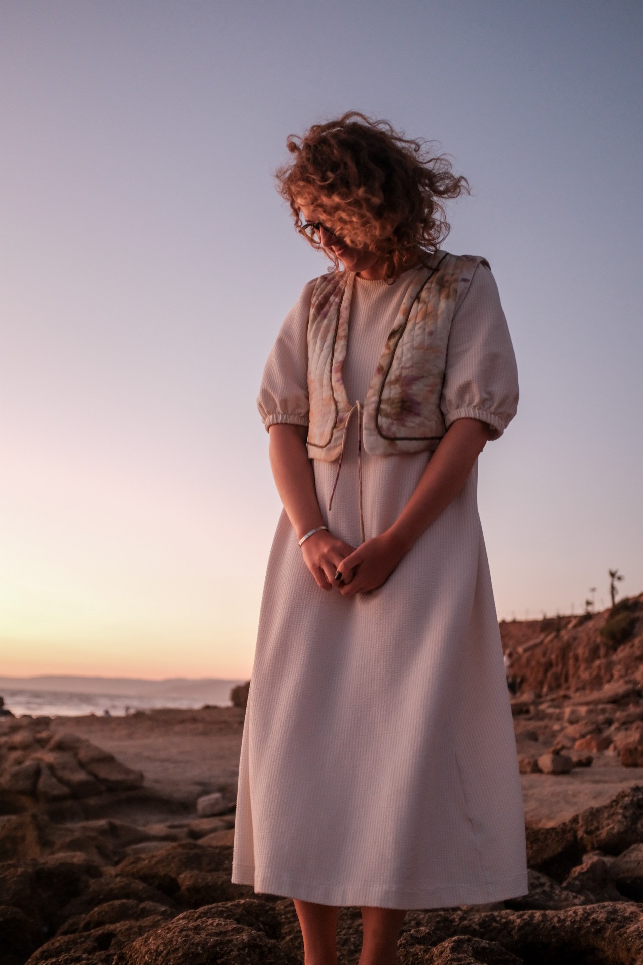 Portrait on a rocky coastline at sunset